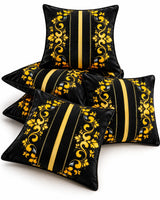 Black cushion covers with golden floral scrollwork, vertical gold stripes and elegant ornamental detailing.