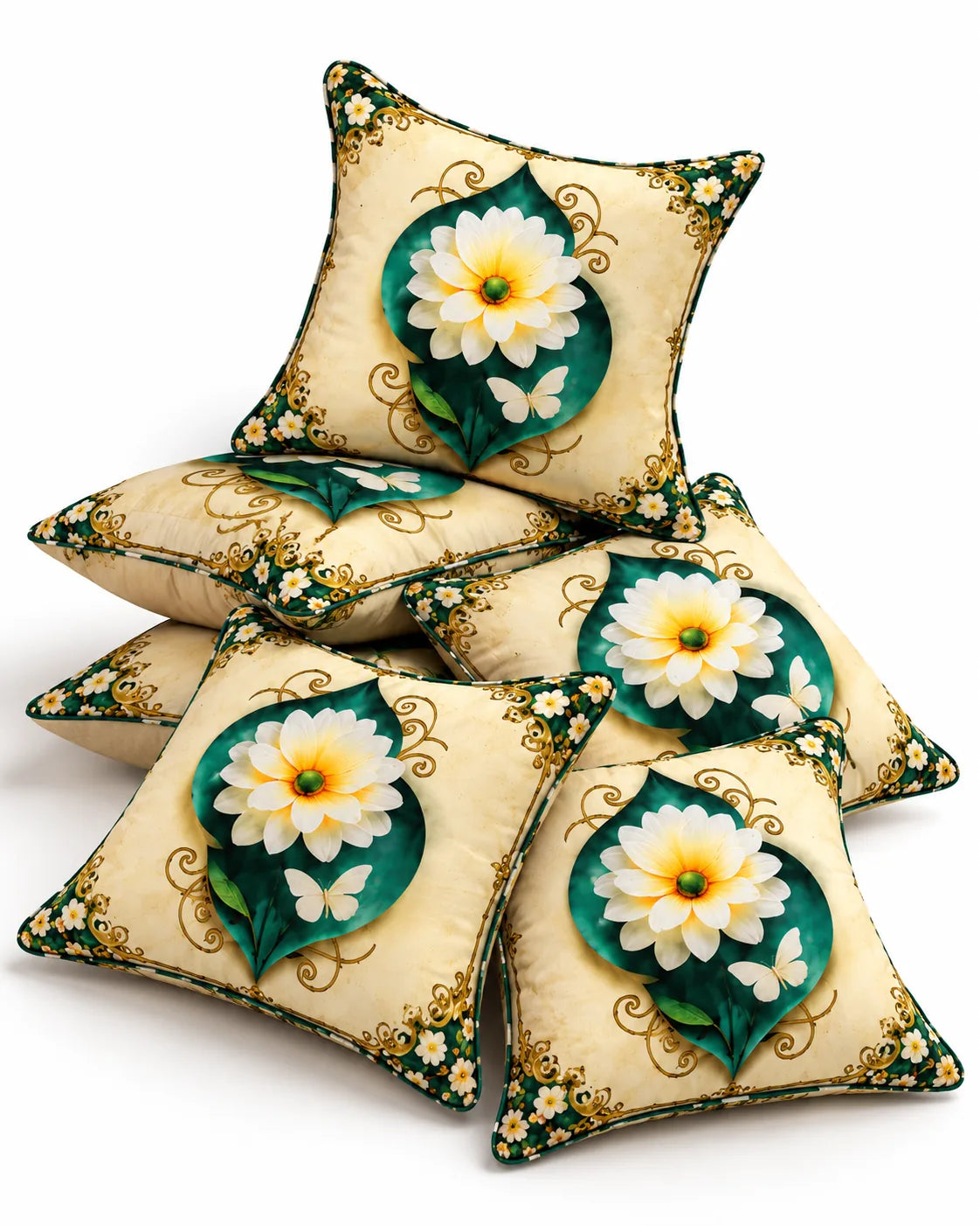 : Cream cushion covers featuring white floral motifs, emerald green leaves and golden ornamental borders arranged in a decorative set.