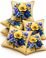 Cream cushion covers featuring vibrant yellow flowers, blue and violet blossoms, green leaves and decorative golden-brown detailing.
