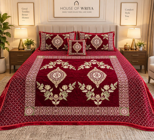 Maroon velvet bedsheet set with floral design and matching cushion covers styled on a luxury bedroom