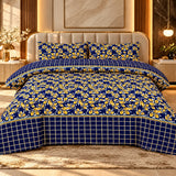 Navy blue bedsheet with mustard-yellow and white floral prints, a matching checkered border and two pillow covers on a luxury bed.