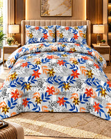 A bed dressed in a colorful floral and botanical print bedding set, featuring a white base with blue, orange, and yellow flowers and leaves, styled in a modern, warm-toned bedroom.