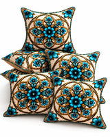 Turquoise blue and gold floral cushion covers with ornamental medallion patterns on a cream sofa.