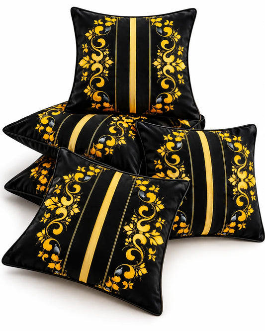 Black cushion covers with golden floral scrollwork, vertical gold stripes and elegant ornamental detailing.