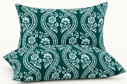 Teal green floral pillow covers set of 2 with white paisley design styled on a luxury bedroom