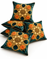 Teal green cushion covers with intricate gold floral medallions, orange rose motifs and gold piping on a white background