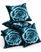 Turquoise blue rose cushion covers with black and white floral detailing arranged on a white background.